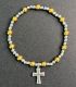 Brazalete bicolor con cruz